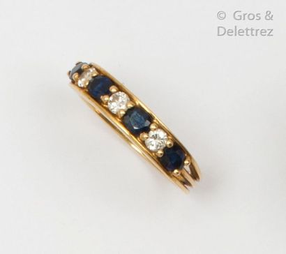 null Yellow gold wedding band adorned with oval facetted sapphires alternating with...