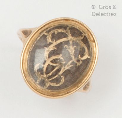 null Yellow gold ring, decorated with a number surmounting a plate of braided hair....