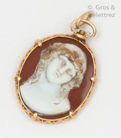 null Yellow gold pendant with openwork volutes and foliage, decorated with a cameo...