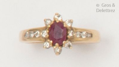 null Flower" ring in yellow gold, adorned with an oval ruby in a surround and shouldered...