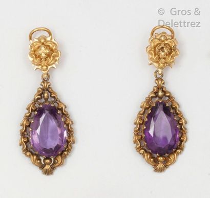 null Pair of chased yellow gold earrings, each adorned with a pear-shaped amethyst....