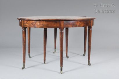 null Oval dining table with walnut and walnut veneer extensions, resting on eight...