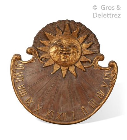 null Large, partially gilded terracotta sundial showing an anthropomorphic sun on...
