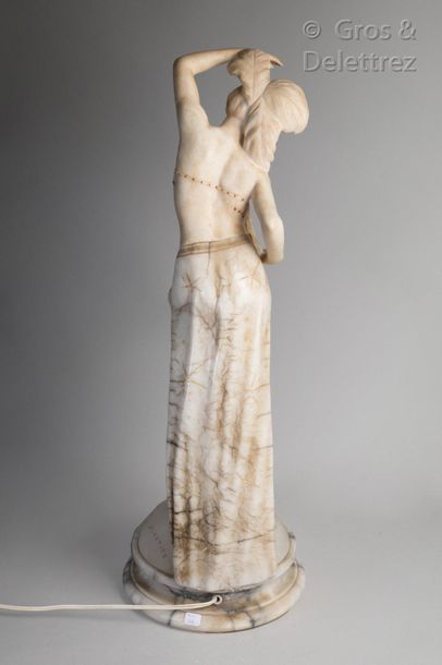 TRAVAIL VERS 1930. Sculpture in alabaster depicting a dancer wearing a veil and feathers...
