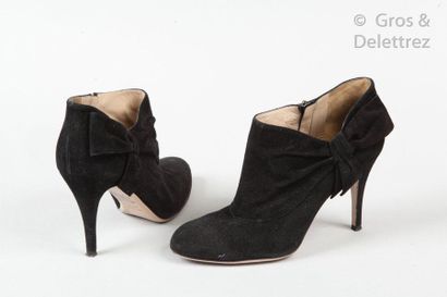 VALENTINO Pair of black suede lambskin low boots, one side decorated with a bow pattern,...