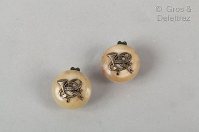 HERMES Paris *Pair of blond horn ear clips with a hunting horn pattern.