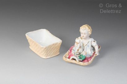 null Porcelain toy chest representing a child in a basket with toys.

German-made,...