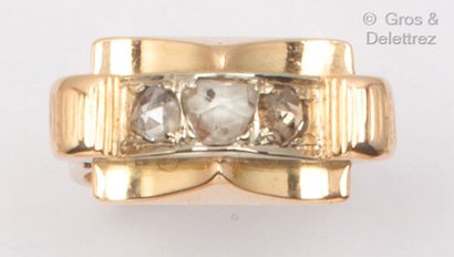 null Bague à pont en or jaune, ornée de trois diamants taillés en rose. Vers 1940....