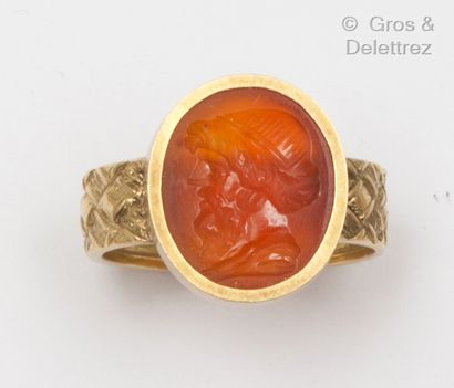 null Yellow gold guilloché ring, decorated with an intaglio on cornelian representing...