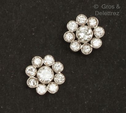 null Pair of white gold "Flowers" earrings, each adorned with a brilliant-cut diamond...
