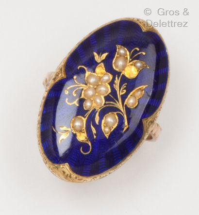 null A chased yellow gold ring set with blue enamel and a flower motif set with half...