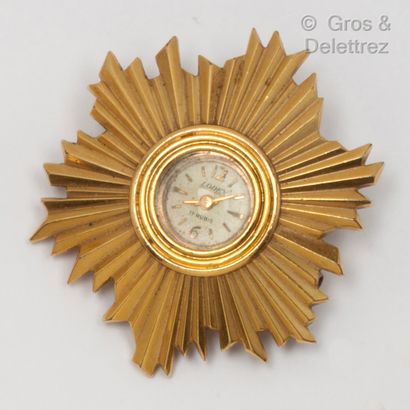 null Pendant brooch in yellow gold, featuring a radiating motif holding a LODEX mechanical...