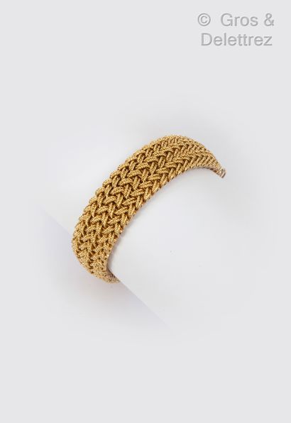 VAN CLEEF and ARPELS Flexible bracelet in braided yellow gold. Circa 1960. Signed...