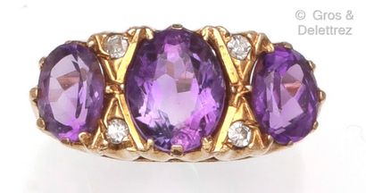 null Ring " Jarretière " in yellow gold (14K), set with three amethysts underlined...