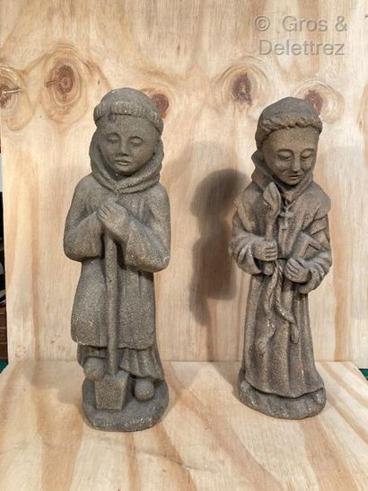 null Pair of reconstituted stone sculptures depicting two Franciscans, one holding...
