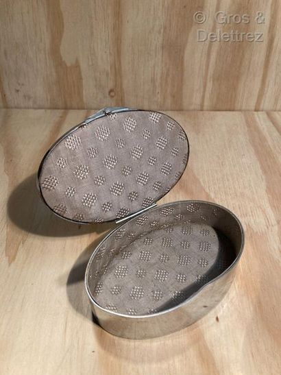 null French work, circa 1930. 

Oval box in silvered metal with an ochre patina and...