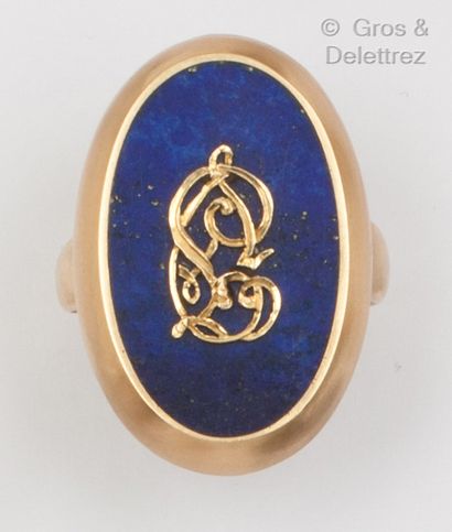 null Bague en or jaune, ornée d’une plaque de lapis-lazuli surmontée d’un monogramme....