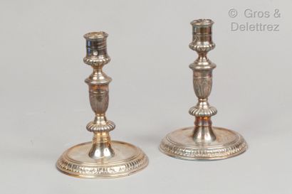 null Pair of toilet candlesticks in re-silvered metal, the shaft in baluster with...