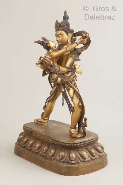 ART SINO-TIBETAIN Large patinated and gilded bronze subject representing a divinity...