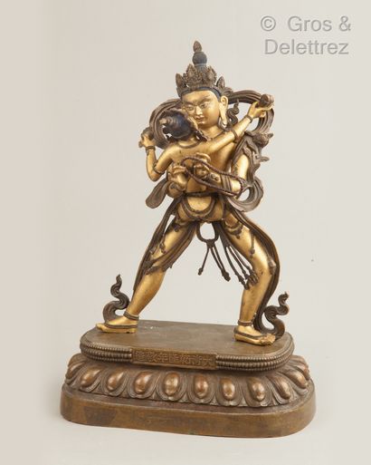ART SINO-TIBETAIN Large patinated and gilded bronze subject representing a divinity...