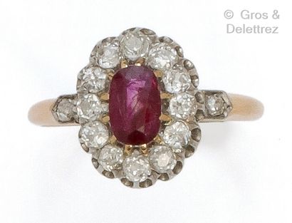 null Yellow gold "Pompadour" ring set with an oval ruby in a setting of old-cut diamonds....