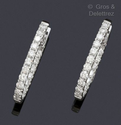 null Pair of white gold oval hoop earrings, entirely set with brilliant-cut diamonds....