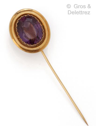 Yellow gold tie pin with an oval amethyst....
