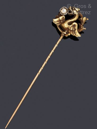 Yellow gold tie pin with a chimera holding...