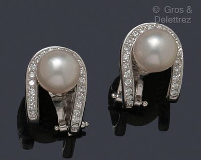 null Pair of white gold earrings decorated with a line of brilliant-cut diamonds...