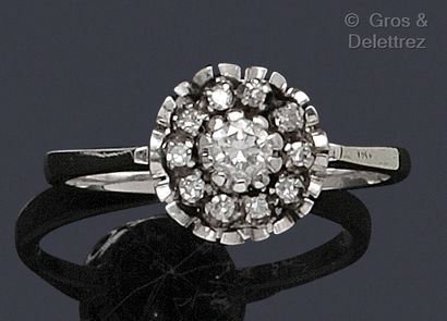 null White gold "Flower" ring, set with a brilliant-cut diamond in a circle of smaller...