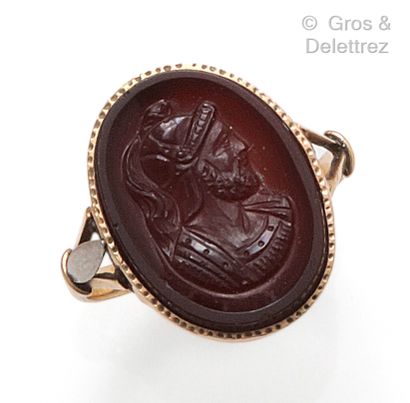 A yellow gold ring set with a carnelian intaglio...