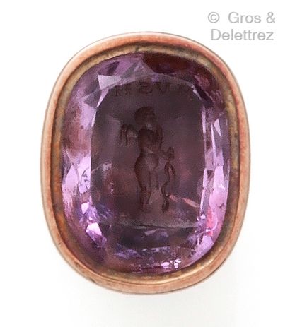  A yellow gold stamp with vine branches holding an intaglio on an amethyst showing...