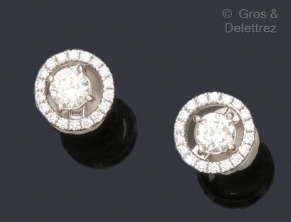 null A pair of white gold earrings, each set with a brilliant-cut diamond in a removable...