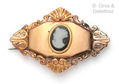 null A yellow gold brooch with a cameo on agate in an openwork setting of rocaille...