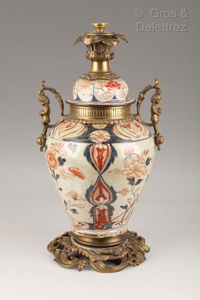 null A covered Imari enamelled porcelain vase decorated with birds and plants.

Height:...