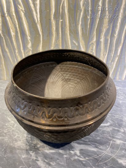 null Circular brass baluster pot with repoussé decoration of large leaves on a hammered...