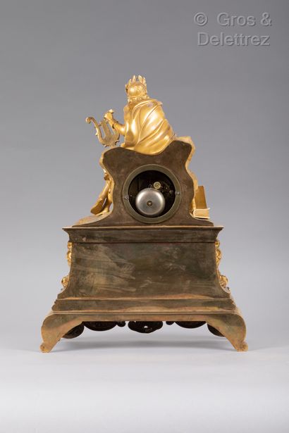 null Gilt bronze clock representing a poet with a laurel head sitting on a rock,...