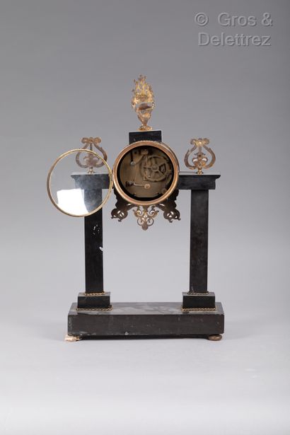 null 
Portico clock decorated with gilded bronze and black marble canephores. The...