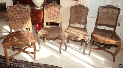 null A set of four caned chairs in natural wood, moulded and carved with flowers...