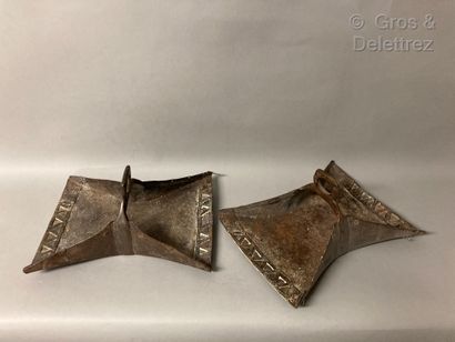 null Pair of very large iron stirrups decorated with a frieze of straps.

Middle...