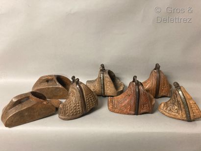 Set of seven wooden stirrups carved with...