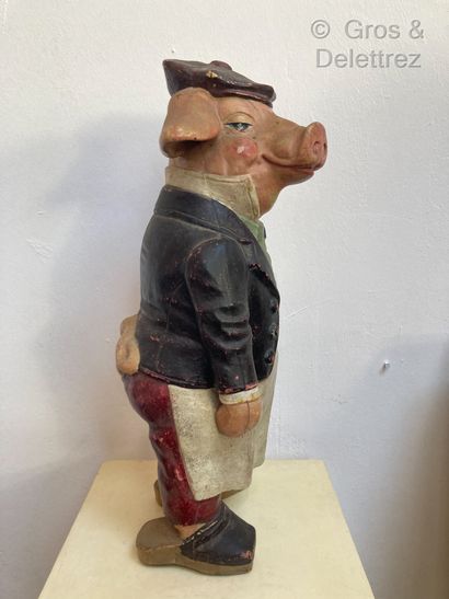 null Large figurine in painted clay representing a pig with a blue tie dressed as...