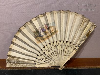 null Bone fan partially openwork with volutes and an engraving of a country family...