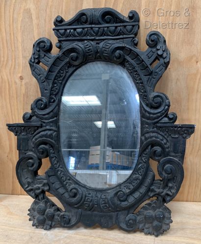 null Blackened wood mirror with a rich carved decoration of cut leather, acanthus...