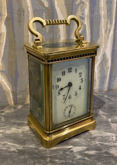 null (Study)Brass travel clock with ivory dial with Arabic numerals, in the lower...