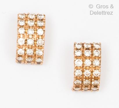 A pair of rose gold earrings, each with a...