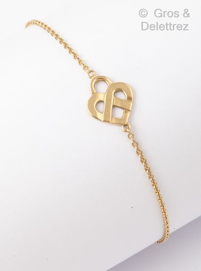 POIRAY "Interlaced Heart" - Yellow gold bracelet with a chain holding an interlaced...