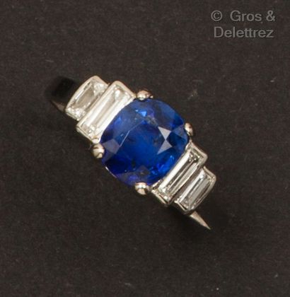 Platinum ring set with an oval faceted sapphire...