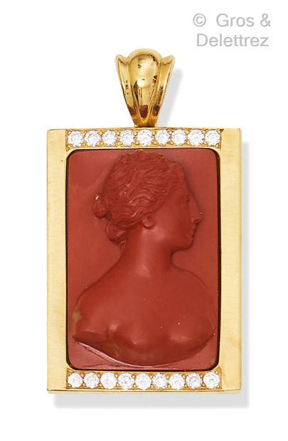 A rectangular yellow gold pendant with a...