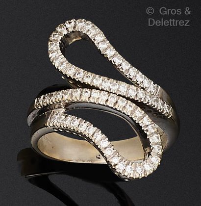 An openwork white gold ring set with lines...